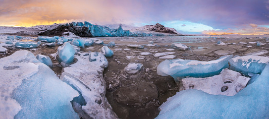Famous Fjallsarlon glacier and lagoon with icebergs swimming on frozen water.
