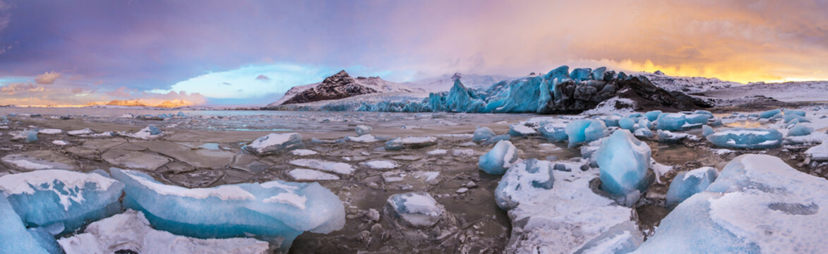 Famous Fjallsarlon glacier and lagoon with icebergs swimming on frozen water.
