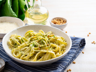 Tagliatelle pasta with pesto sauce made of Basil, garlic, pine nuts, olive oil. Side view
