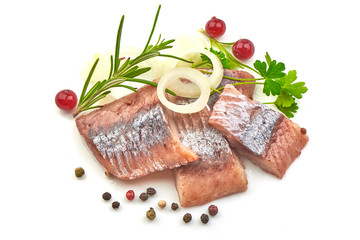 Sliced Marinated Herring Fillet with onion ring, pepper and herbs, isolated on a white background.