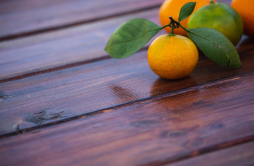 Tangerine with Leaves on Old Wooden Table. Copy Space