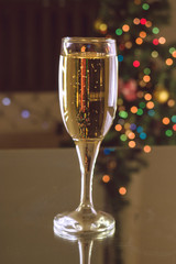 New Year's Eve. Two tables on the table. Champagne in a glass.