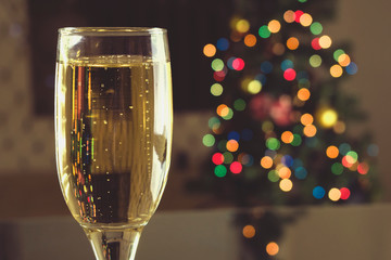 New Year's Eve. Two tables on the table. Champagne in a glass.