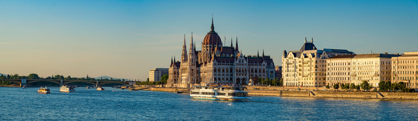 Fototapeta premium HUNGARY, BUDAPEST. The view across the river Danube to the mighty parliament building in the warm light of a late afternoon is outstanding