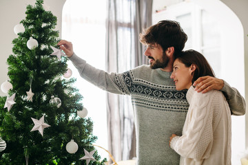 Couple celebrating Christmas at home.