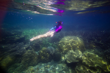 Fototapeta na wymiar Woman swimming in water, Beautiful woman under water before dive to coral reef, woman snorkeling in blue mask, snorkel woman face in mask, tropical sea snorkeling, summer vacation activity