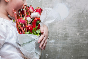 Bouquet. Vegetables. Girl holding a bouquet of vegetables
