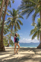 Woman pose on the tropical island with palms tree on the beach. Asian travel to the Philippine islands