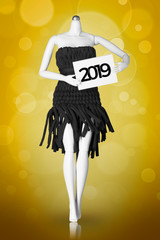 Happy New Year 2019. Mannequin with 2019 sign on golden  bokeh background
