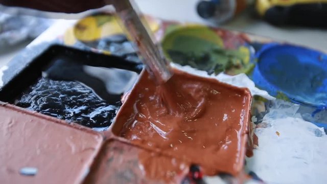 Painter mixing colors of paint 