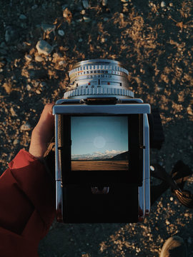 Person taking photo with retro camera