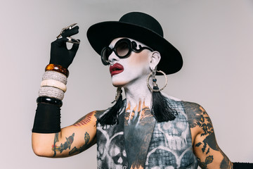 Bizarre fashion studio portrait with extreme makeup