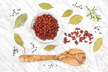 Red beans and spices on marble background