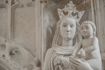 Ancient statue of Maria and Chris as baby at her hands, Magdeburg, Germany, details, closeup