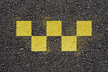 Taxi checks symbol on asphalt