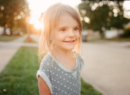 little girl in sunny street