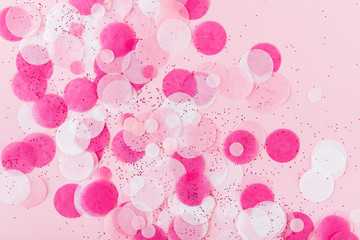 Colorful Confetti on pink Background. top view