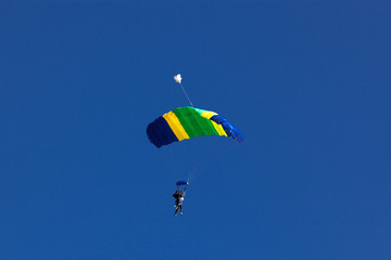 parachuting against blue sky - freedom and adrenaline concept