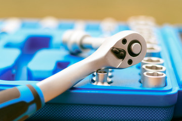 A set of heads in a blue box is not a focal point or a ratchet close-up. shallow depth of cut. there is toning