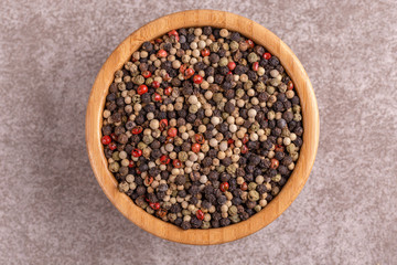 Mix of peppers in bowl on gray marble background