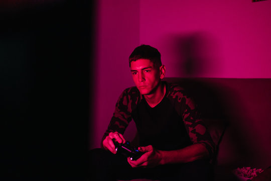 Young man playing?in dark room