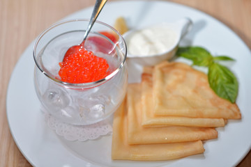 red caviar with pancakes and sour cream