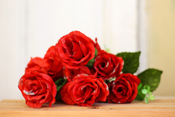 Romantic still life, red roses on wood table. Valentine's day concept.Soft focus