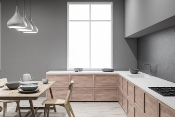 Fototapeta na wymiar Gray kitchen with table, side view