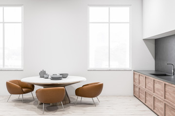 White kitchen interior, round table side view