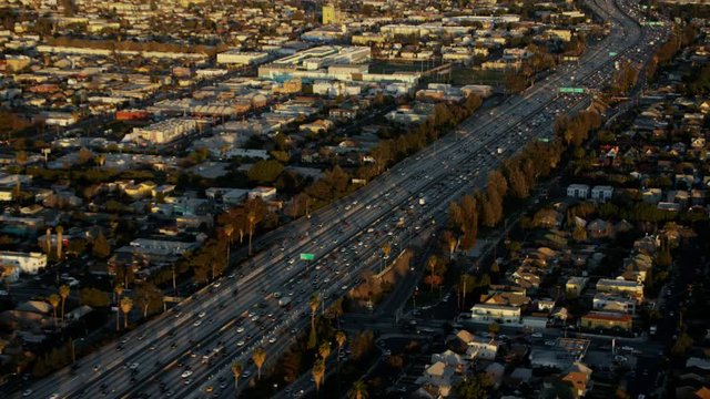 Aerial view at sunset of evening commuters on busy LA freeways