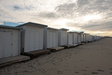 Obraz na płótnie Canvas White wooden cabins on the beach in France