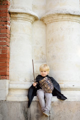 Portrait of a cute little boy dressed as a medieval knight