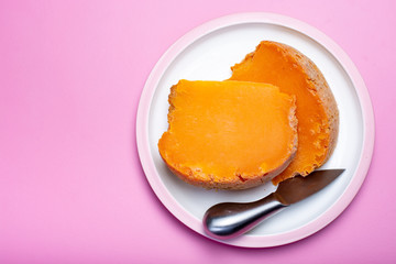Two pieces of native French aged cheese Mimolette, produced in Lille with greyish curst made by special cheese mites