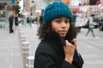 Portrait of young woman in city in cold weather