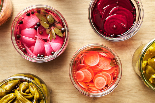 CLose-up of colorful pickled vegetables in jars