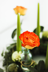 Traditional yet modern German Advent wreath, a round circle with evergreen and fir branches, four candles and festive holiday or christmas decoration such as baubles or glass ornaments