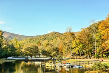  Fantastic view of colorful mountain with reflection in the lake at Vogel State park with blue sky white clouds on the background, Autumn in GA USA.