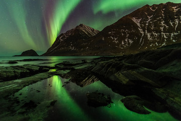 Norway - Lofoten island - aurora reflexion in pool in Haukland