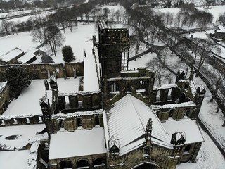 Snow covered ruins of an old abbey and church, aerial view