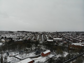 Aerial photo over looking fields and houses in the Snow, taken in Leeds West Yorkshire UK