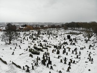 Cemetery graveyard on a winters day covered in Snow, taken in Leeds West Yorkshire