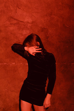 young androgyne man in small black dress dancing