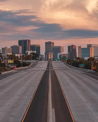 Empty San Diego Freeway with Sunset Sky - Vertical view of San Diego, California, USA Skyline with empty freeway in foreground. The 5 freeway travels most of the coast of the western united states © Robert