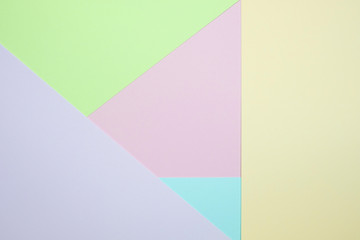 Obraz premium Fashionable pastel colored paper flat lay top view, geometric background texture, pink, purple, yellow, beige, green and blue.