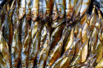 golden smoked herrings fish sold in wet market. overhead