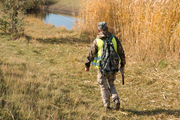 Hunters with a german drathaar and spaniel, pigeon hunting with dogs in reflective vests	