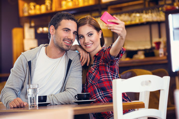 couple taking photo in cafe