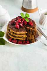 gluten-free green buckwheat pancakes with fresh berries and maple syrup. Delicious vegan breakfast . healthy food for the whole family. Moka pot with morning coffee