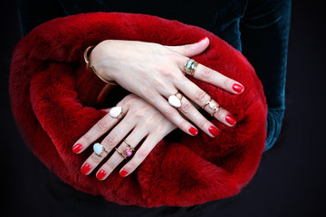 Czerwone manicure. Kobiece dłonie w czerwonym manicure i eleganckim futrze.
