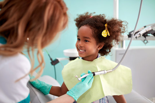 Cute kid show her teeth to dental assistant